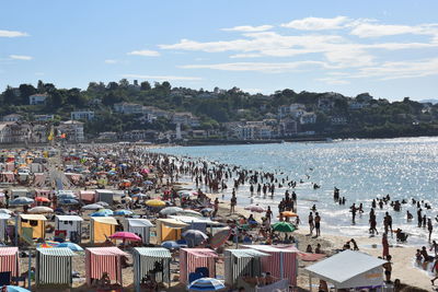 High angle view of people at beach against sky