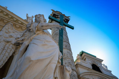 Low angle view of statue against blue sky