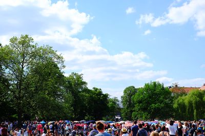 People enjoying in park against sky