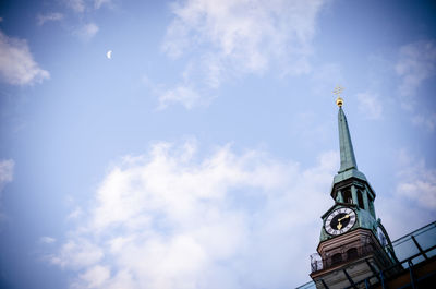 Low angle view of building against cloudy sky