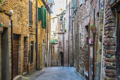 Narrow alley amidst buildings in city