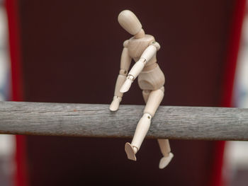 Close-up of wooden figurine on railing