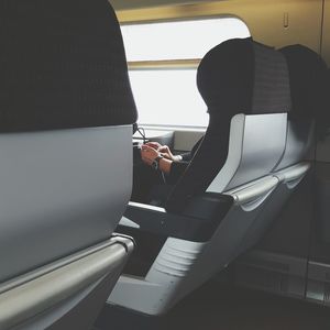 Cropped image of person traveling in train