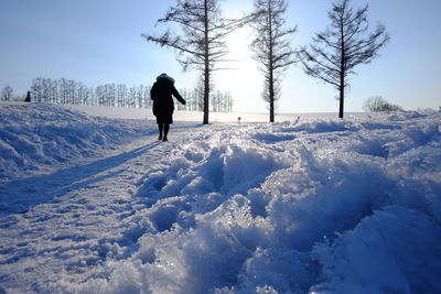 Full length of man on snow field against sky