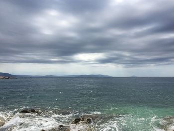 Scenic view of sea against storm clouds