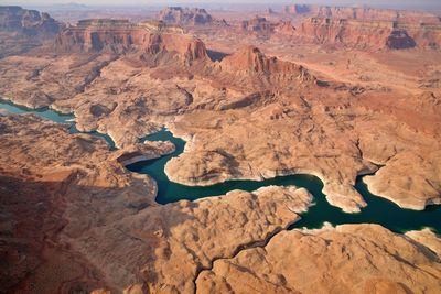 Aerial view of river flowing amidst canyon