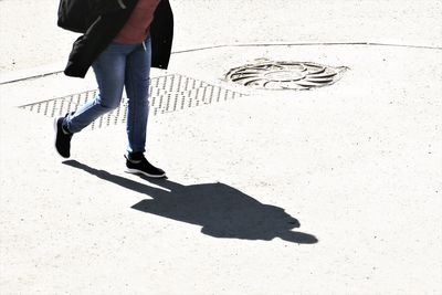 Low section of man standing on footpath