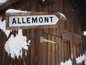 Signboard on wooden house during winter