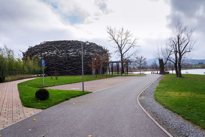 Empty road in park against sky