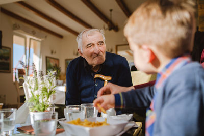 Man and woman sitting on table at restaurant