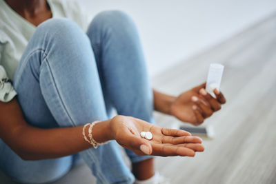 Midsection of woman using mobile phone