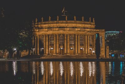 Reflection of building in water at night