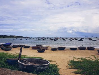 High angle view of boats moored on beach against sky