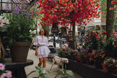 Woman standing by potted plant