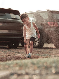 Full length of man climbing on field against sky