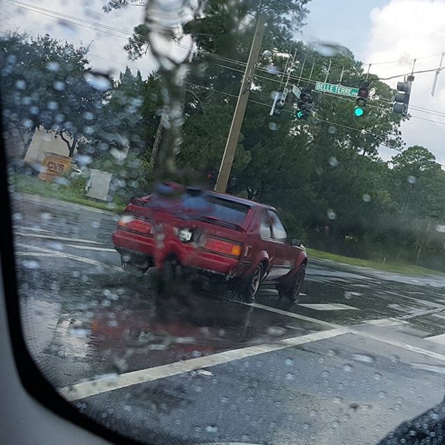 transportation, mode of transport, land vehicle, car, tree, windshield, glass - material, vehicle interior, road, street, transparent, travel, on the move, red, car interior, wet, public transportation, train - vehicle, rain, day