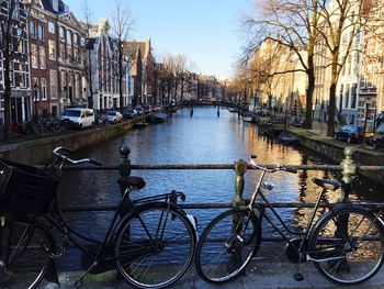 Cars parked in front of canal