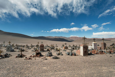 Panoramic view of people on land against sky