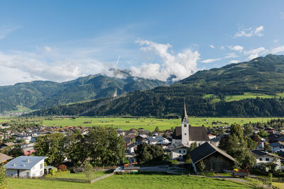 Scenic view of trees and buildings against sky