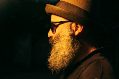 Portrait of trendy bearded man wearing hat and sunglasses