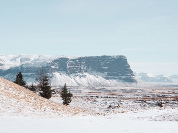 Scenic view of snowcapped mountains against clear sky