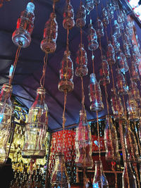 Low angle view of illuminated lanterns hanging at market stall