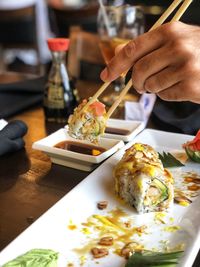 Midsection of person preparing food in restaurant