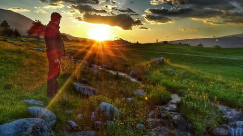 Scenic view of field against sky during sunset