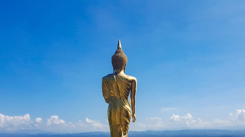 Low angle view of statue against blue sky