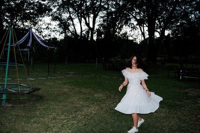 Young woman spinning on playground