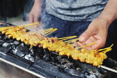 Midsection of man preparing food