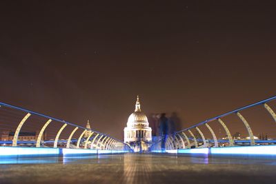 Illuminated bridge at night