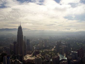 High angle view of cityscape against cloudy sky