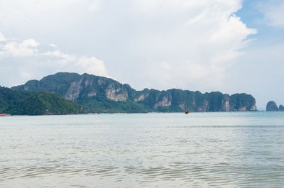 Scenic view of sea and mountains against sky