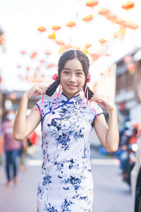 Portrait of young woman standing outdoors