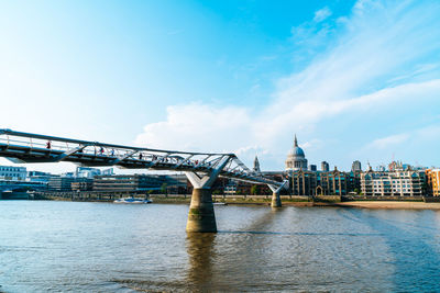 Bridge over river with buildings in background