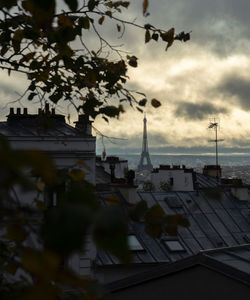 Houses and buildings against sky at sunset