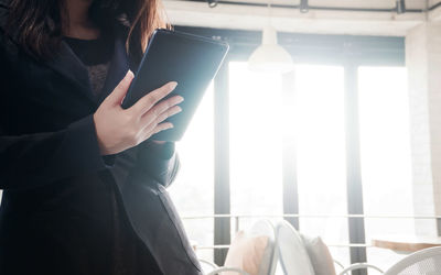 Midsection of woman using smart phone