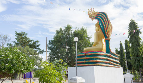 Low angle view of statue against temple