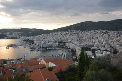 High angle view of townscape by river against sky