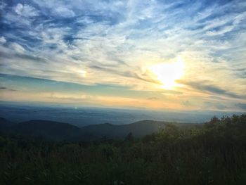 Scenic view of landscape against cloudy sky