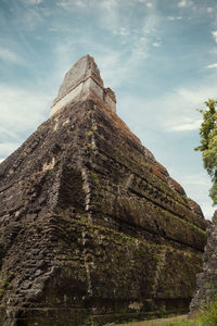 Low angle view of rock formation against sky