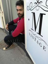 Young man sitting in box