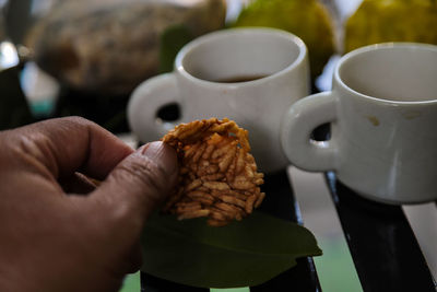 Midsection of person holding coffee cup