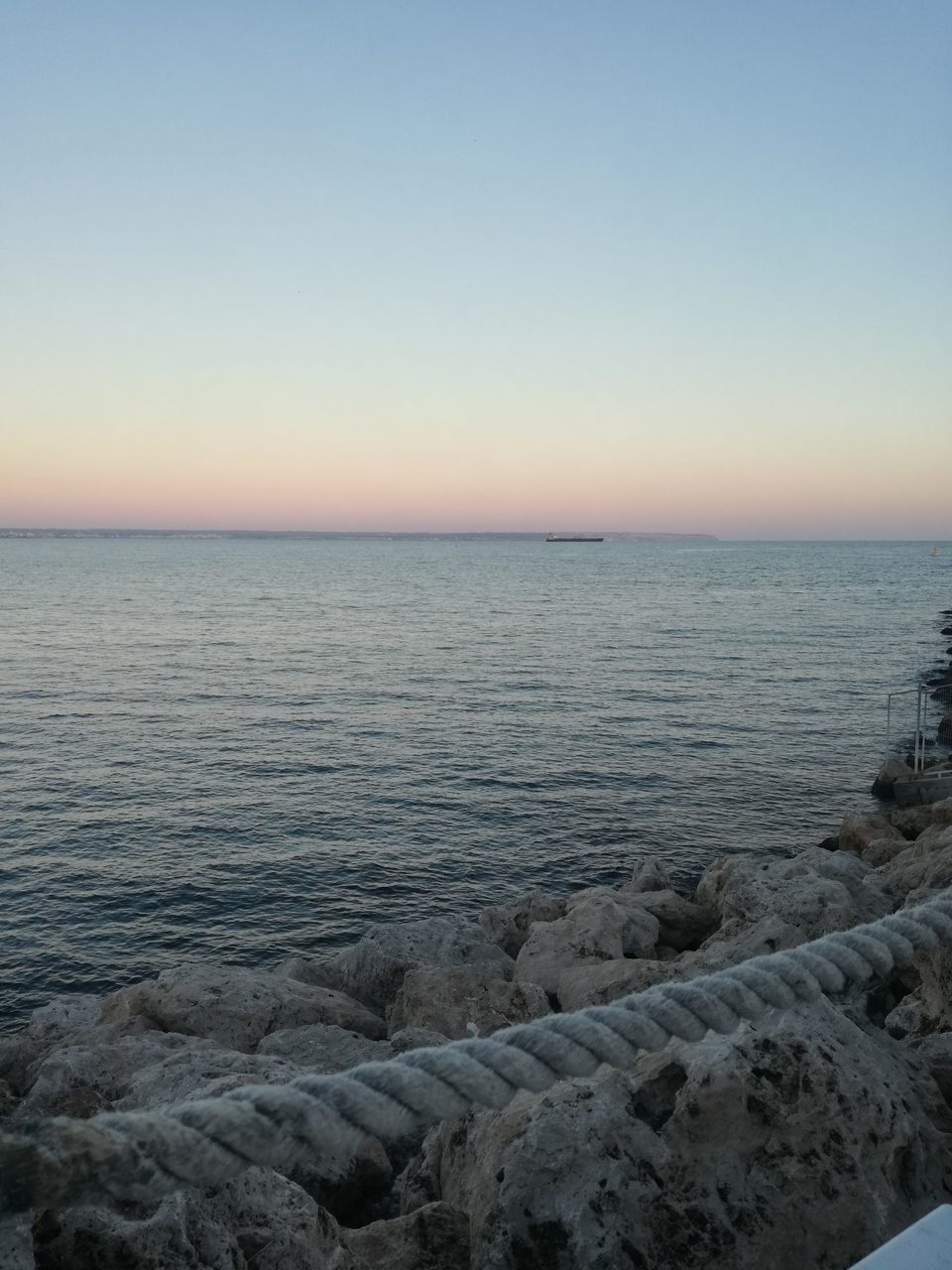 sea, nature, tranquility, tranquil scene, beauty in nature, scenics, water, horizon over water, idyllic, outdoors, sunset, sky, copy space, no people, clear sky, beach, day