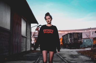 Portrait of woman standing against sky