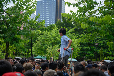 Rear view of people standing by plants