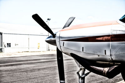 Airplane on runway against sky