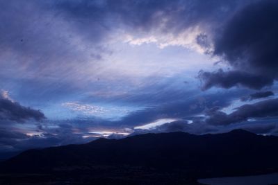 Scenic view of mountains against cloudy sky