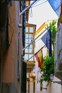 Row of flags hanging amidst buildings